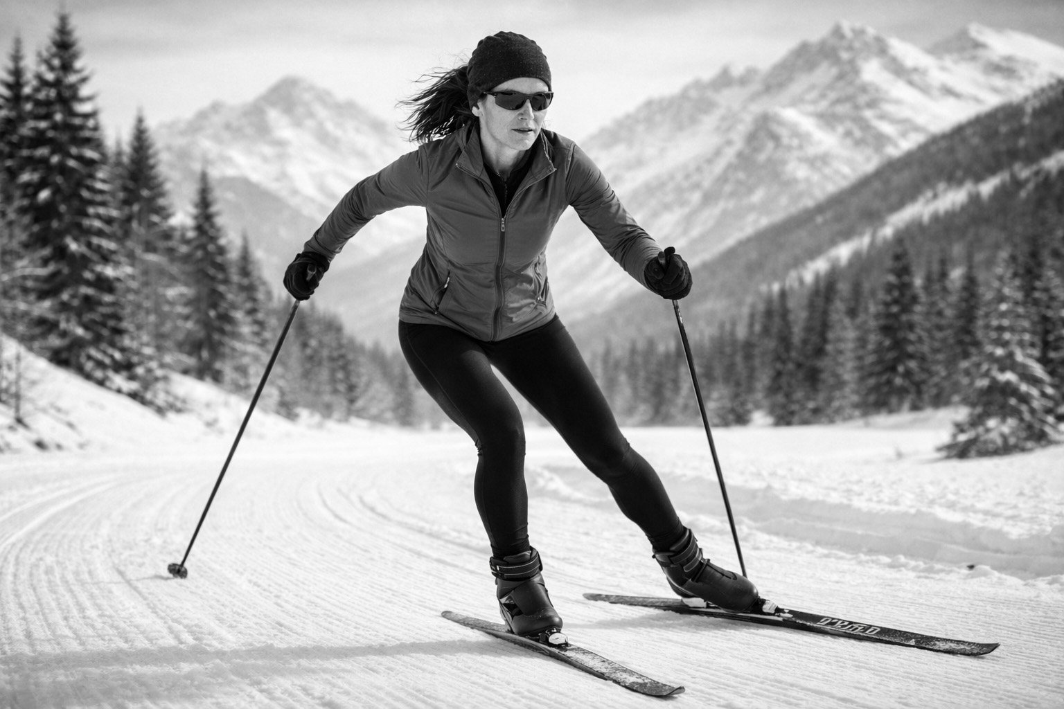 Fit woman skate cross-country skiing on a mountain trail, representing outdoor winter fitness, balance, and all-round strength after 45.
